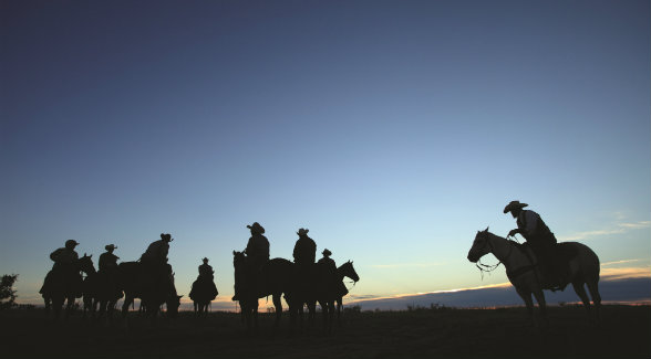 Waggoner Ranch cowboys prepare to ride out at dawn.